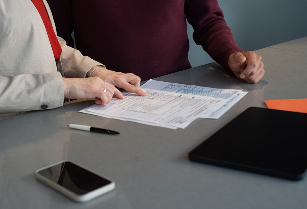 Two people reviewing a printed monthly report together