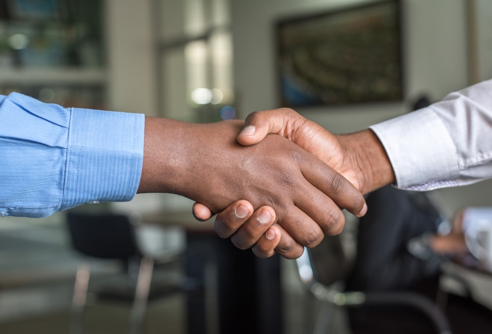 Two people shaking hands to start a new business relationship