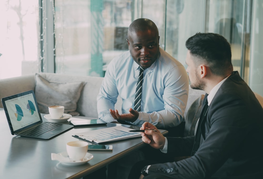 Two people going over growth results together on a laptop